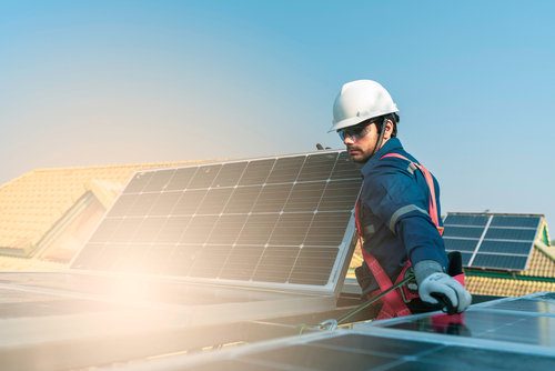 Technician installing solar panels