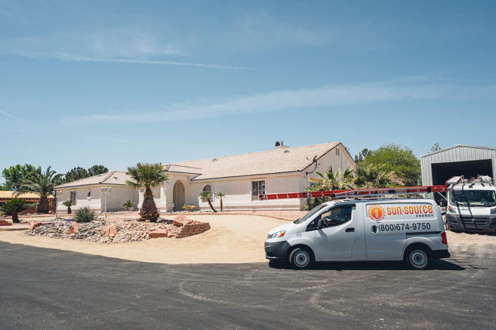 sun source truck infront of a home preparing to do a solar panel installation. 