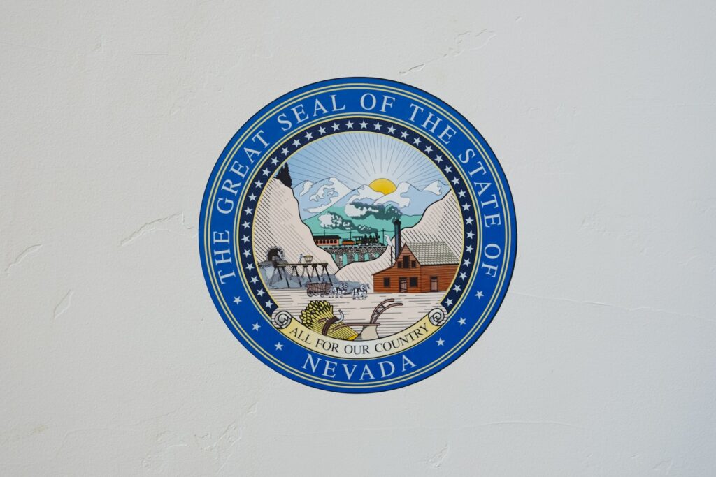 The Great Seal of the State of Nevada logo on white wall