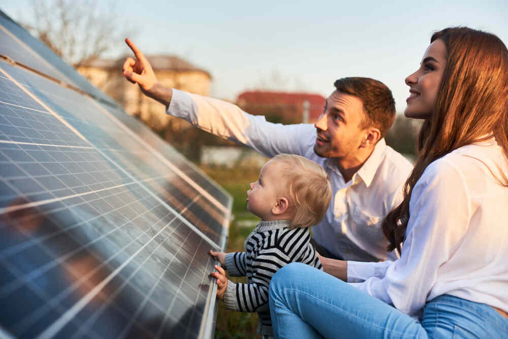 A family admiring their new solar panels.
