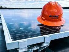Solar panels and a worker's hard hat.