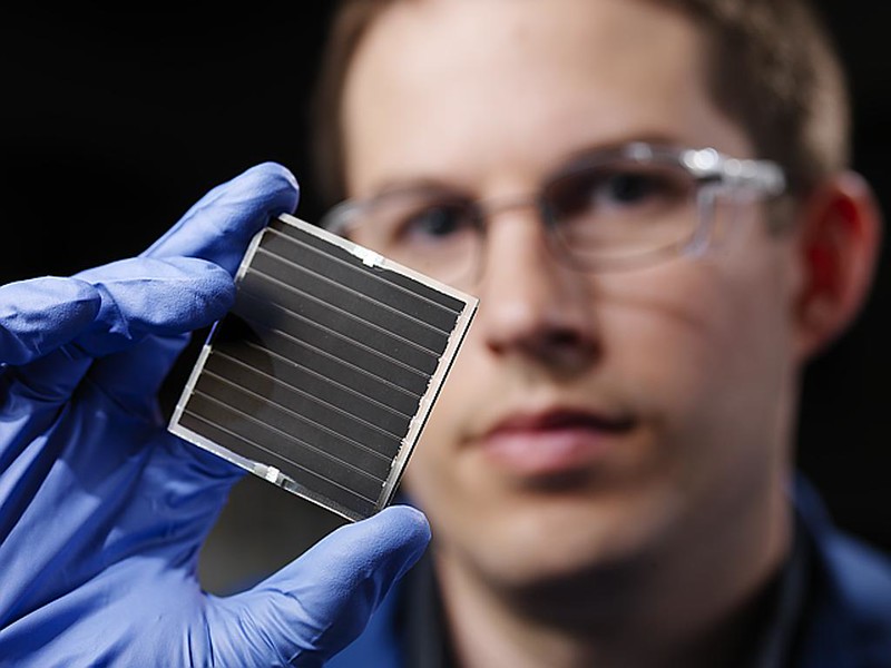 scientist holding a new solar cell